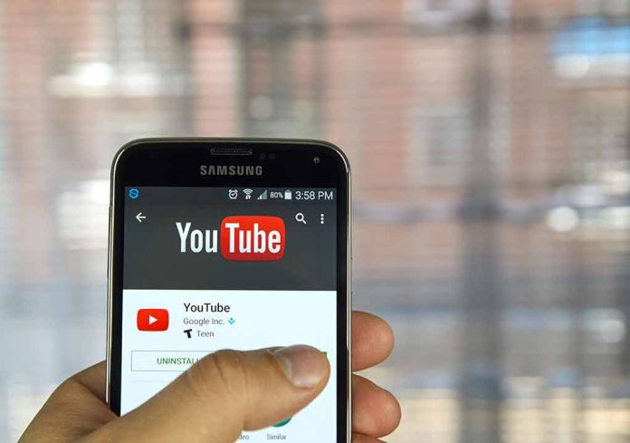 402805636 featured image Hand holding smartphone with YouTube app open