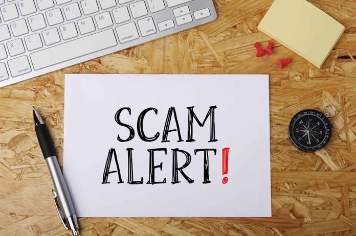 594304802 featured image Scam alert message on a wooden desk.