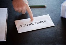 Envelope with YOU'RE FIRED and pointing finger