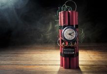 Dynamite bundle with a clock timer on wooden floor