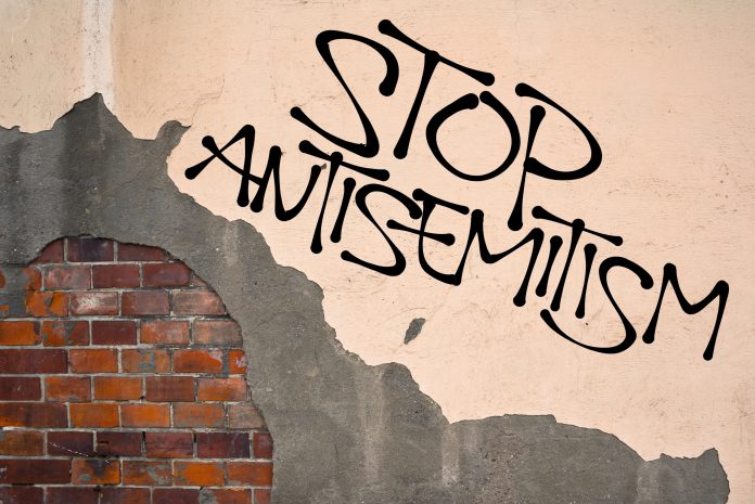 Stop Antisemitism - handwritten_437195251.jpg featured image Stop antisemitism graffiti on a worn brick wall