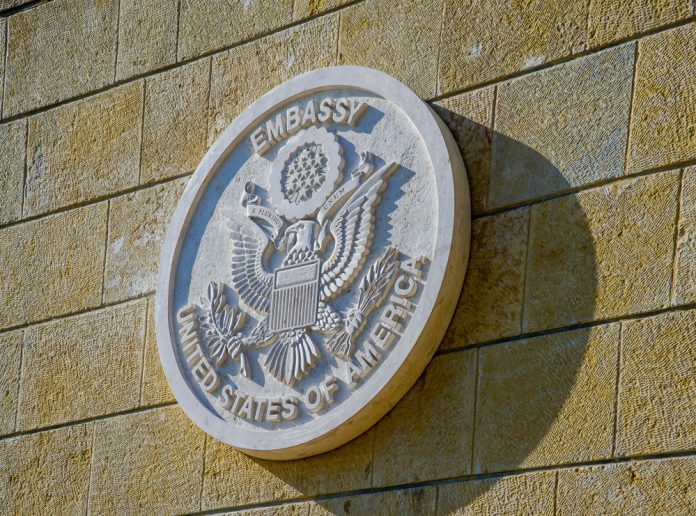 1092812744 featured image United States of America embassy emblem on wall