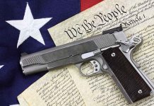 Gun on US Constitution and flag
