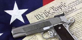 Gun on US Constitution and flag