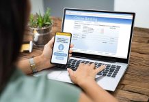 Person using phone and laptop for online banking