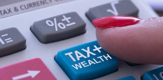 Finger pressing calculator tax and wealth button