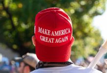 Red Make America Great Again hat on persons head
