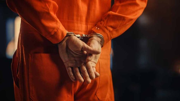 2056434935 featured image Person in orange jumpsuit with handcuffs behind back