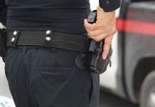 Person holding a gun in a holster