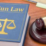Gun Law book and gavel on wooden desk