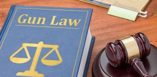 Gun Law book and gavel on wooden desk