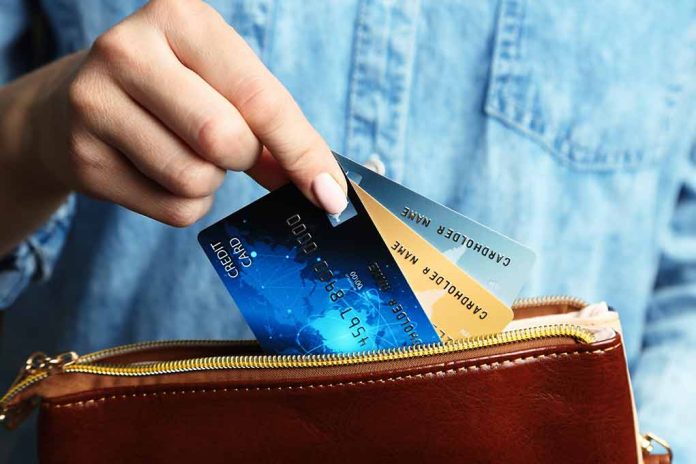453955981 featured image Hand holding credit cards over a brown purse