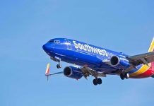 Southwest Airlines plane flying in blue sky.