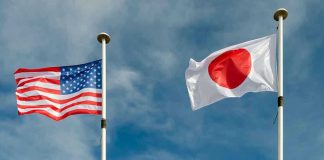 USA and Japan flags flying on flagpoles