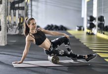 Woman using foam roller in gym setting