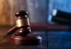 Gavel on wooden table in dimly lit room