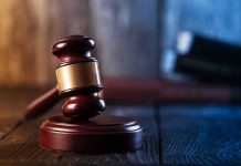 Gavel on wooden table in dimly lit room