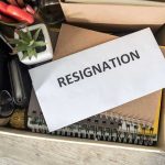 Envelope labeled resignation in a box of office items