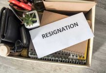 Envelope labeled resignation in a box of office items