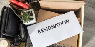 Envelope labeled resignation in a box of office items