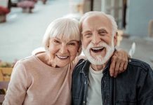Elderly couple smiling together outdoors