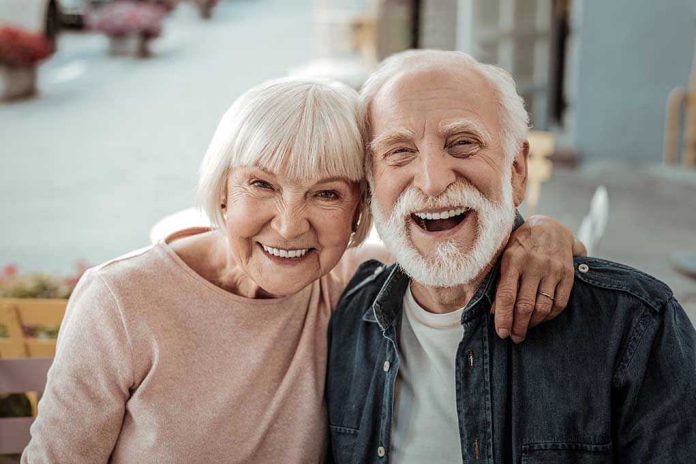 1565185228 Elderly couple smiling together outdoors