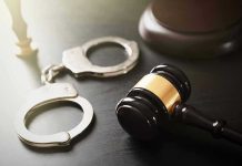 Handcuffs and judge's gavel on the table