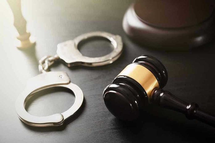 Handcuffs and judge's gavel on the table