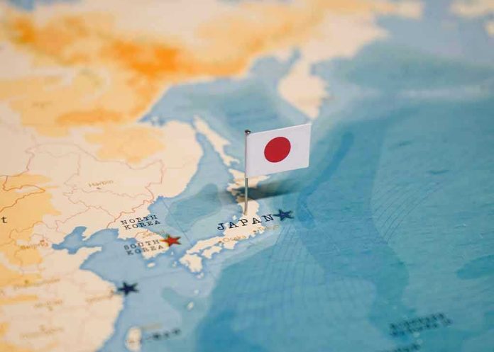 2327414549 Map of Japan with flag pin placed nearby