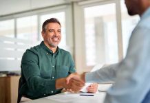 Two professionals shaking hands in an office setting