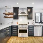 Modern kitchen with black cabinets and stainless appliances.