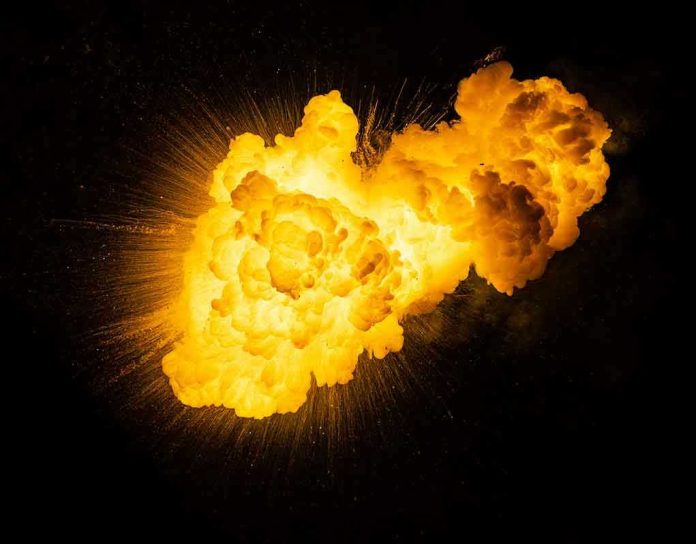 1791558833 Bright vfiery explosion against a dark background