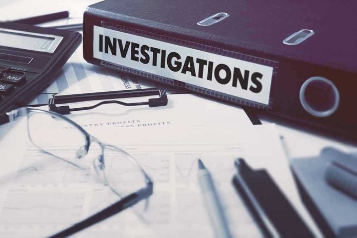377375638 Documents and binder labeled "Investigations" on desk.