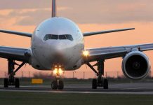 Airplane on runway during sunset