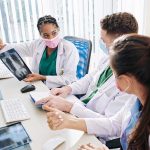 Doctors discussing chest X ray results at a workstation