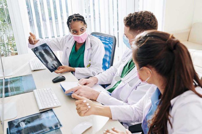 1779923279 Doctors discussing chest X ray results at a workstation