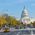 View of the Capitol building in Washington D.C. with autumn trees lining the street