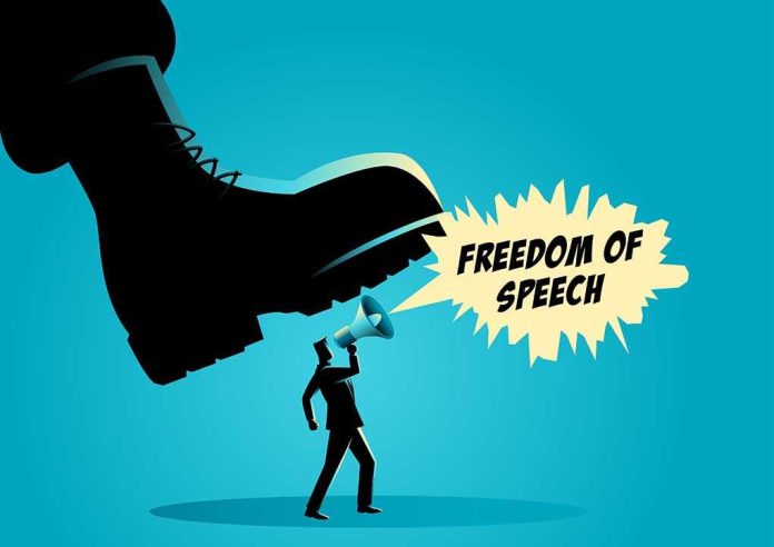 A man holding a megaphone under a large boot, symbolizing censorship of free speech